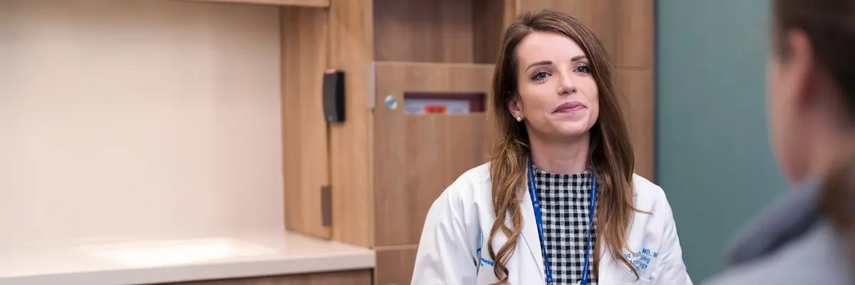 Dr. Diana Roth O’Brien, talking with a patient, is a radiation oncologist at MSK in New York City and in NJ. 