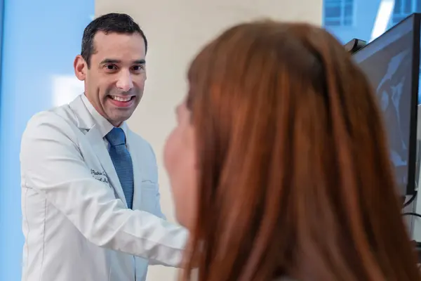 Rehabilitation medicine doctor Jesuel Padro-Guzman is with his patient at MSK in New York City. 