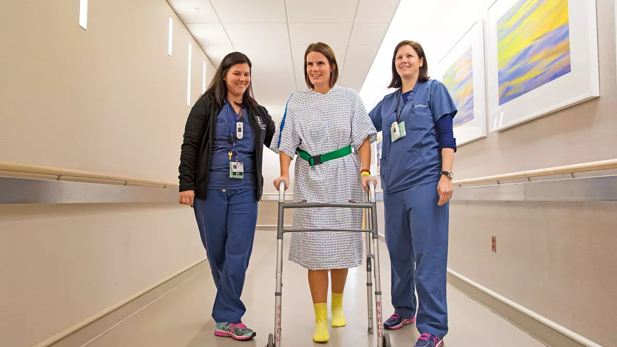 Patient and staff walking in Memorial Hospital