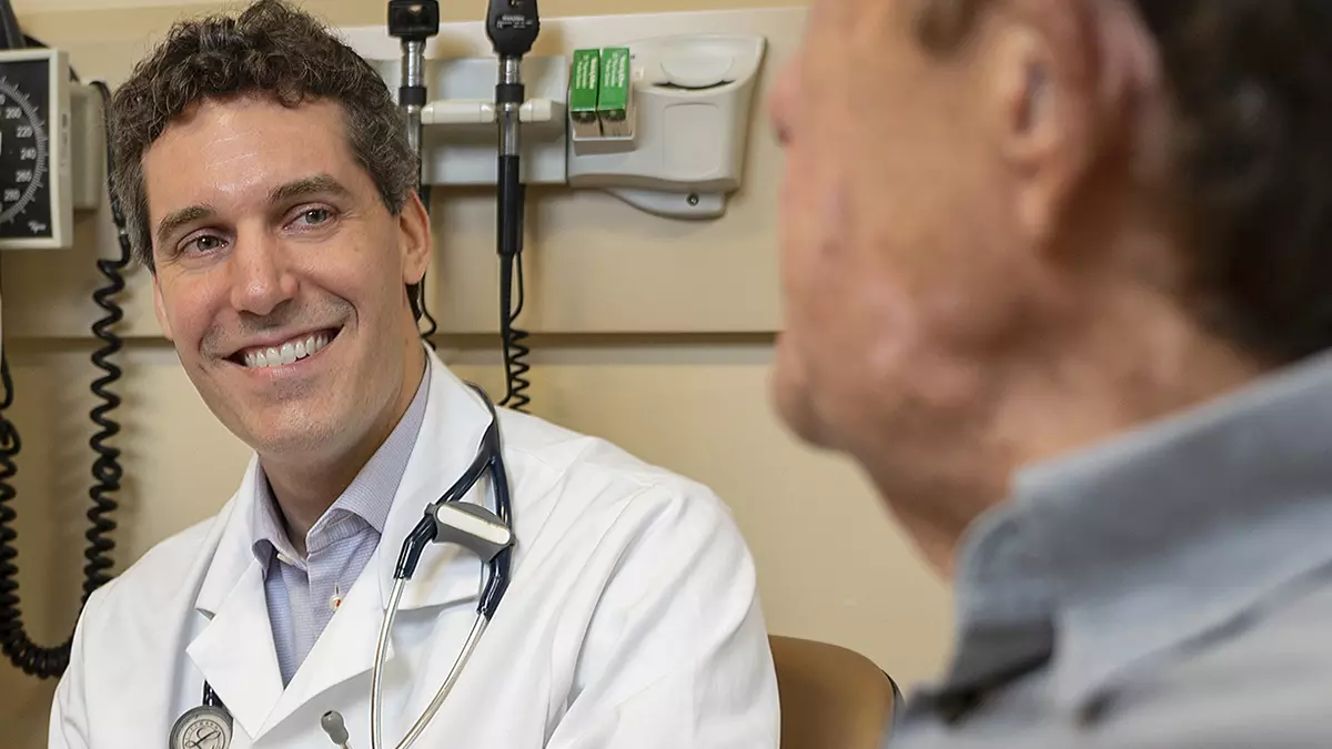 Melanoma Service Chief Michael A. Postow, MD sees a patient.