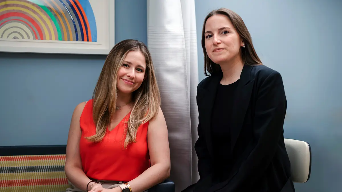MSK social worker Hadley Maya, who supports young people with colorectal cancers, sits with a woman who is her patient. 