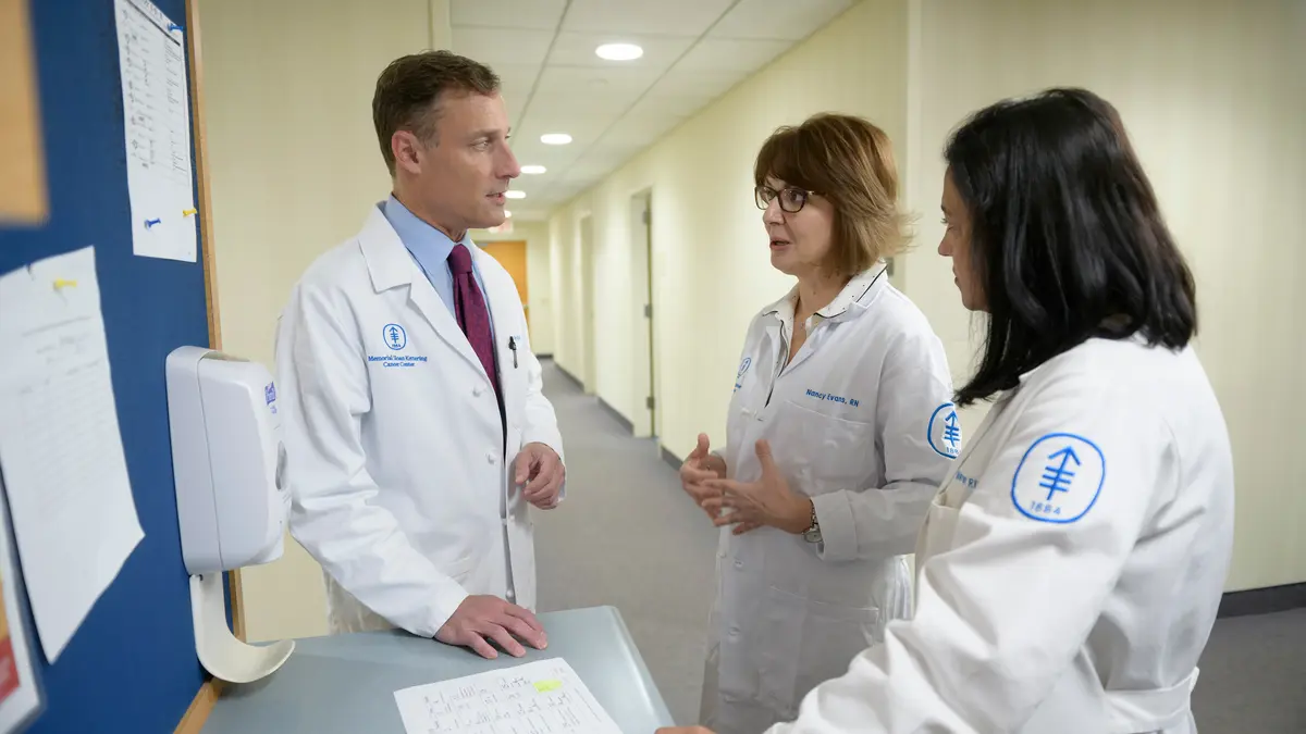 Colorectal surgeon Dr. Martin Weiser, clinical nurse Nancy Evans, and physician assistant Meredith Riffle talk about their patient. 
