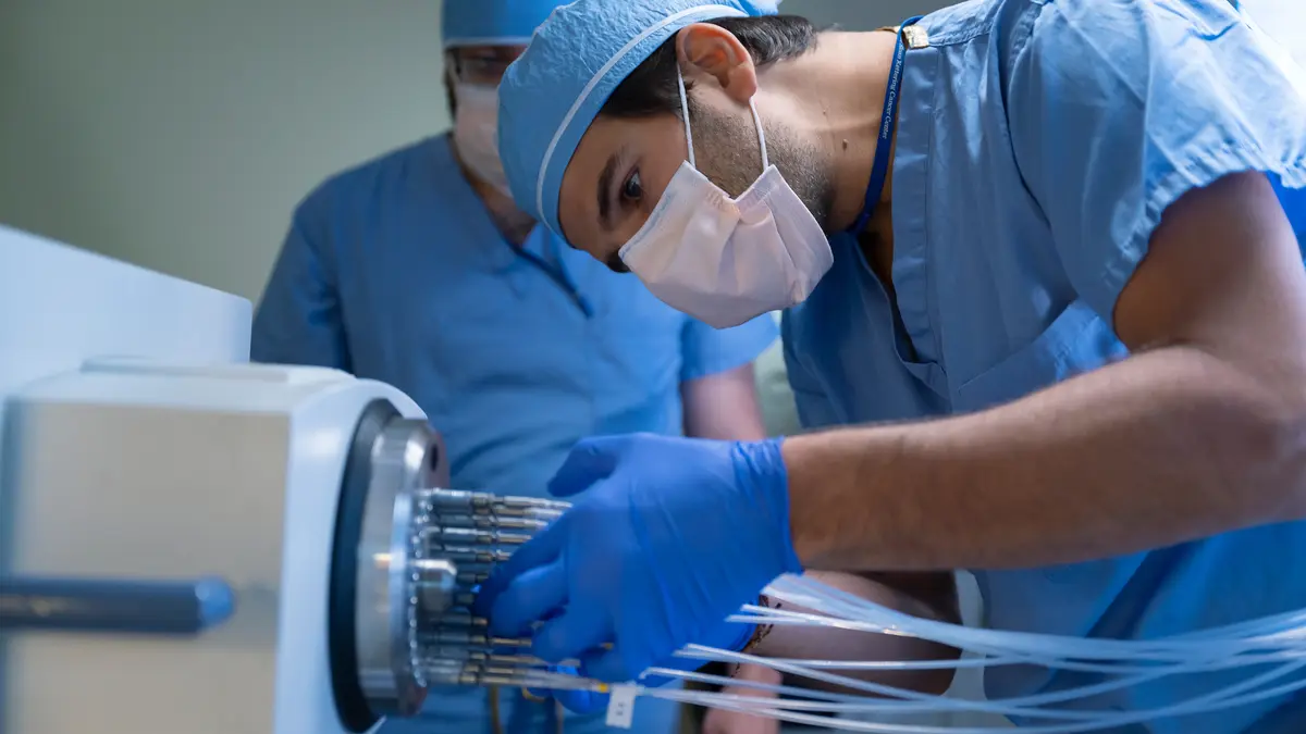 Medical physicist David Aramburu Nunez connects tubes in MSK’s brachytherapy suite. 