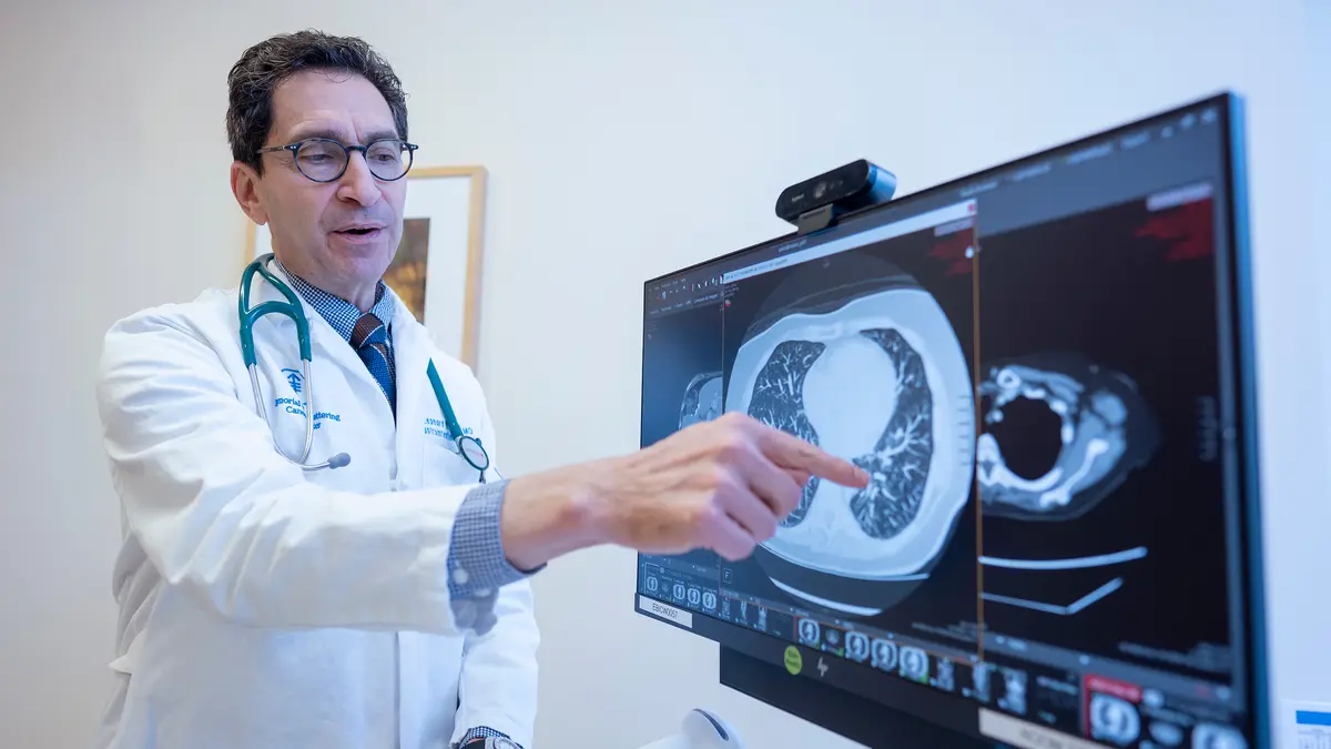 Gastrointestinal medical oncologist Dr. Leonard Saltz points to an image on a computer monitor.  