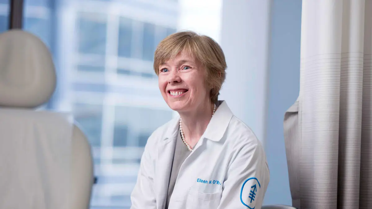 Dr. Eileen O'Reilly seen smiling in an exam room.